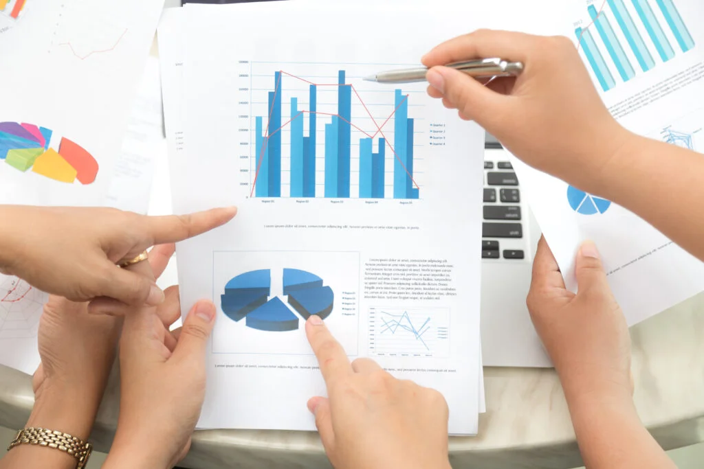 hands pointing statistical document